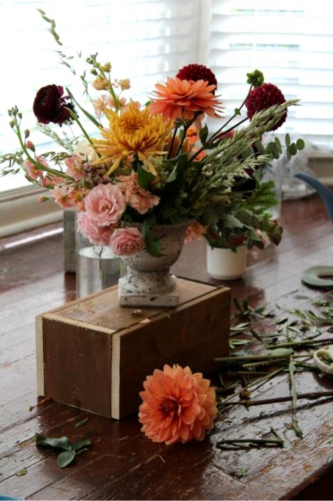 Florist arranging bouquet on table
